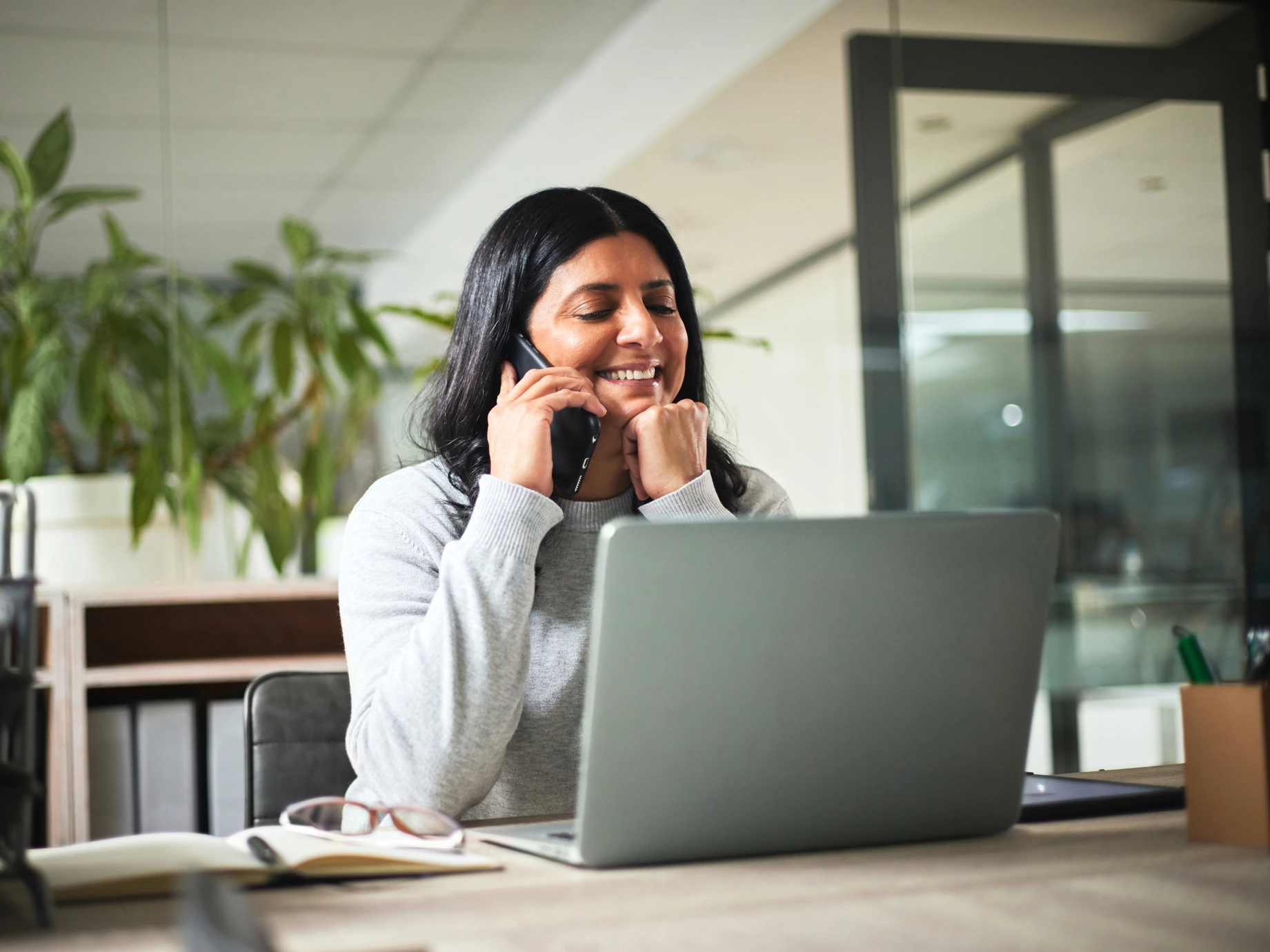 A payroll professional working happily using Chime Workplace