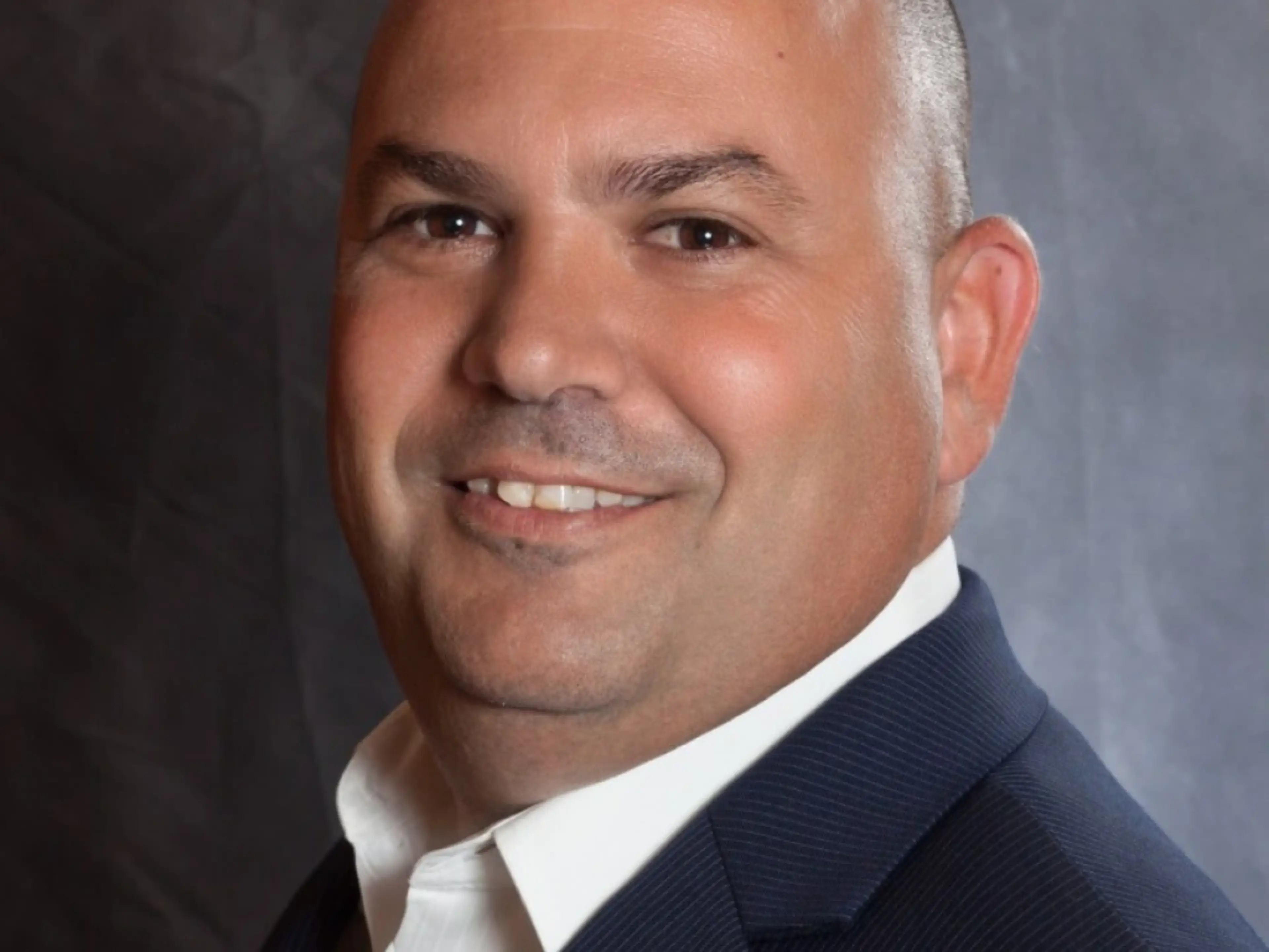 Headshot of Sam Falletta, CEO for Incept, smiling.