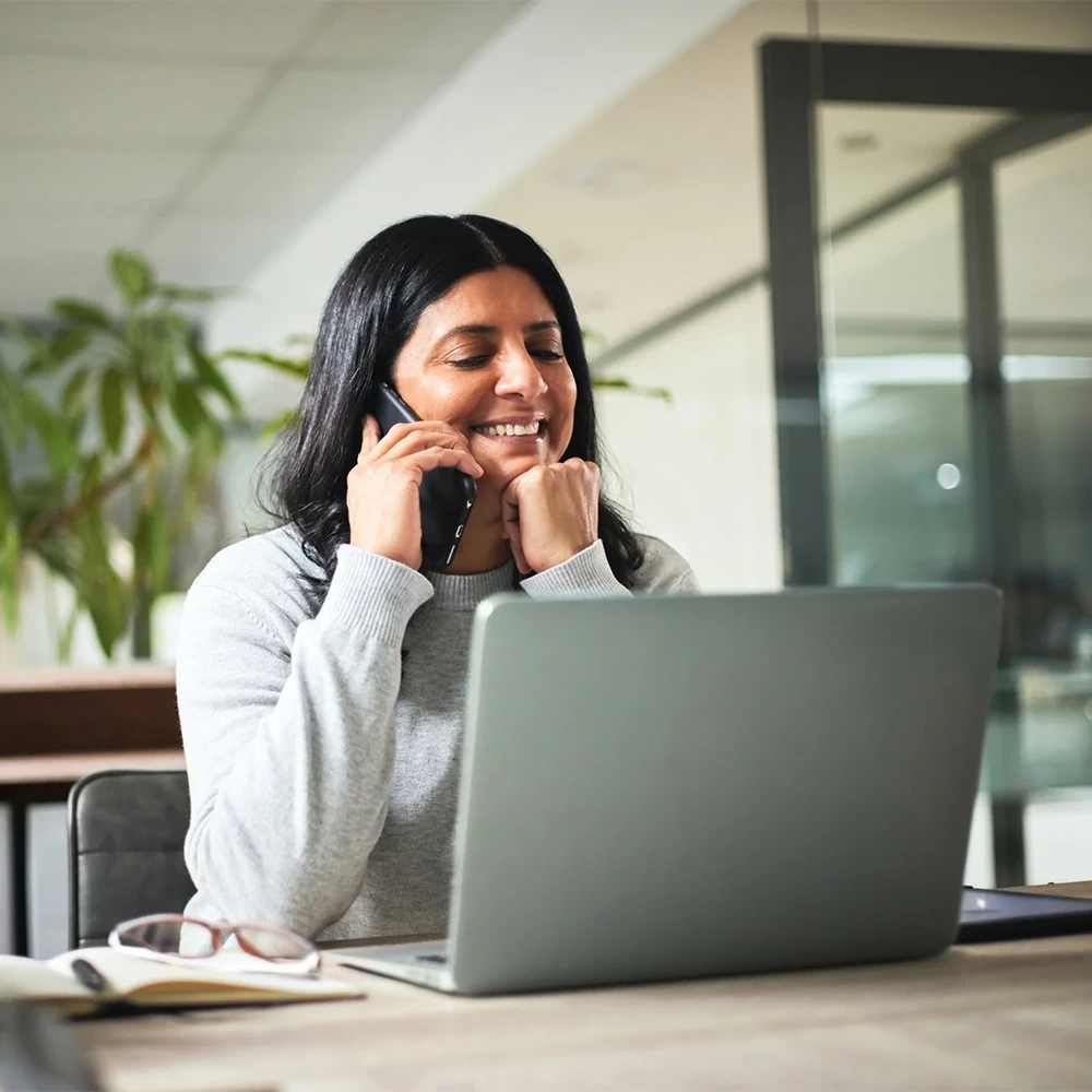 A payroll professional working happily using Chime Workplace.