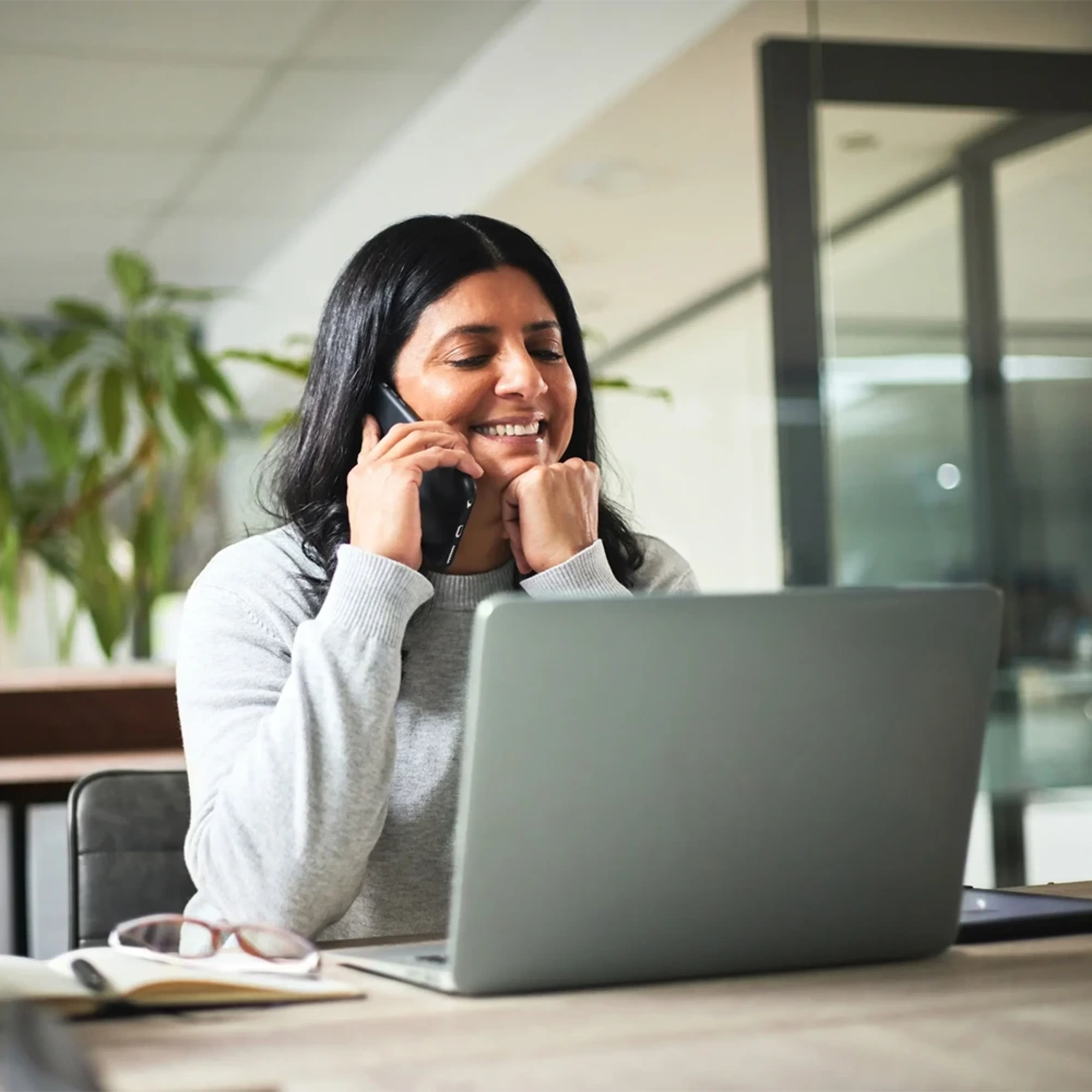 A payroll professional working happily using Chime Workplace.